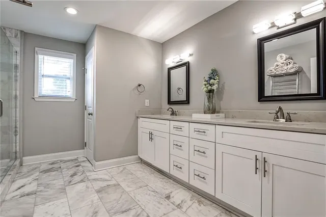 a bathroom with double sink and a mirror
