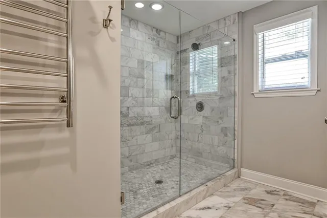 a bathroom with a shower and a sink