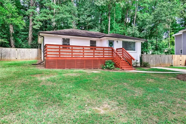 a front view of house with yard and green space