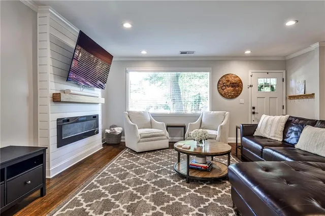 a living room with furniture a rug and a fireplace