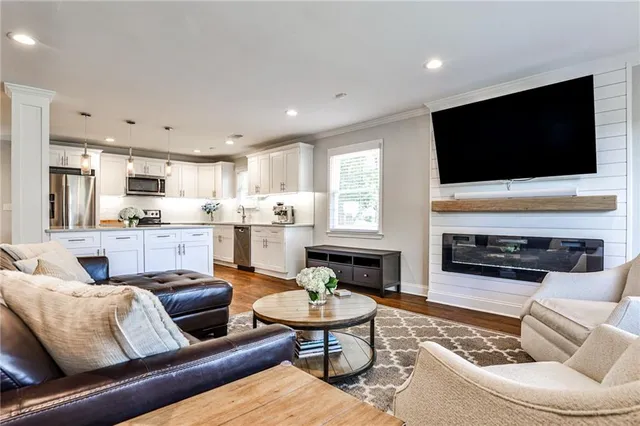 a living room with furniture fireplace and a flat screen tv