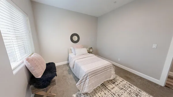 a bedroom with a bed and a window