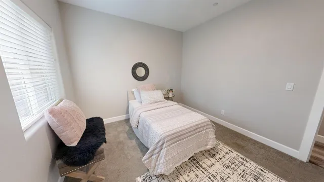 a bedroom with a bed and a window