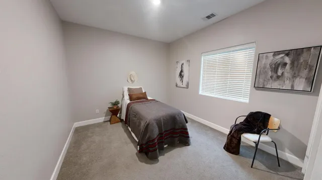 a bedroom with furniture and a window