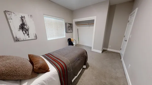 a bedroom with a bed and a window