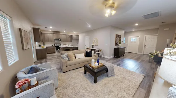 a living room with furniture and a wooden floor