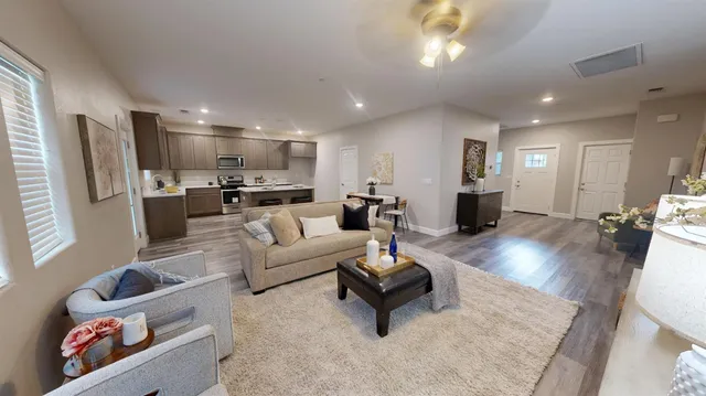 a living room with furniture and a wooden floor