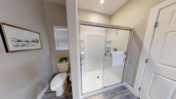 a bathroom with a shower and a toilet