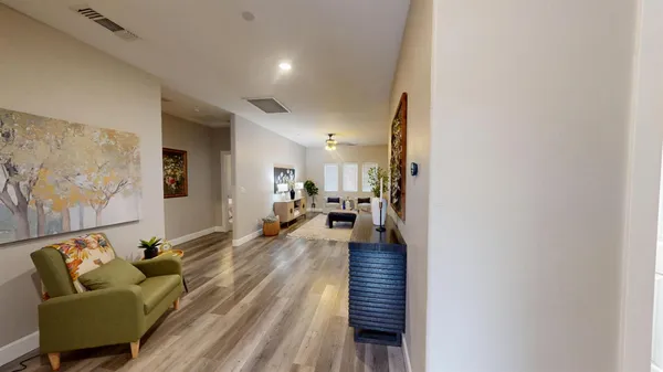 a living room with furniture and a wooden floor