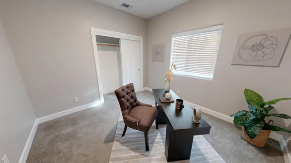 a view of a livingroom with furniture and a potted plant