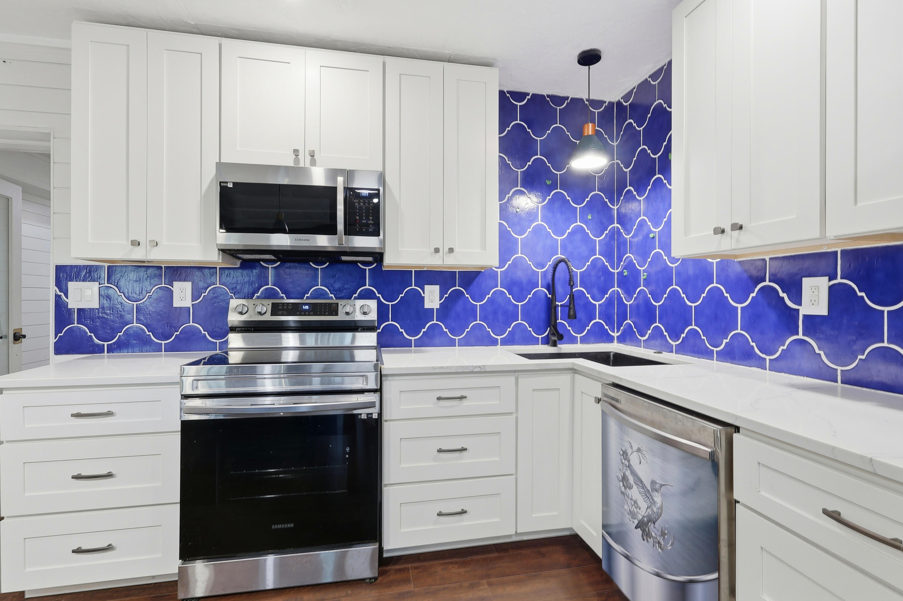 4578 Riley Road Milton, FL 32583 - Photo 14 of 55 a kitchen with stainless steel appliances granite countertop white cabinets and stove top oven