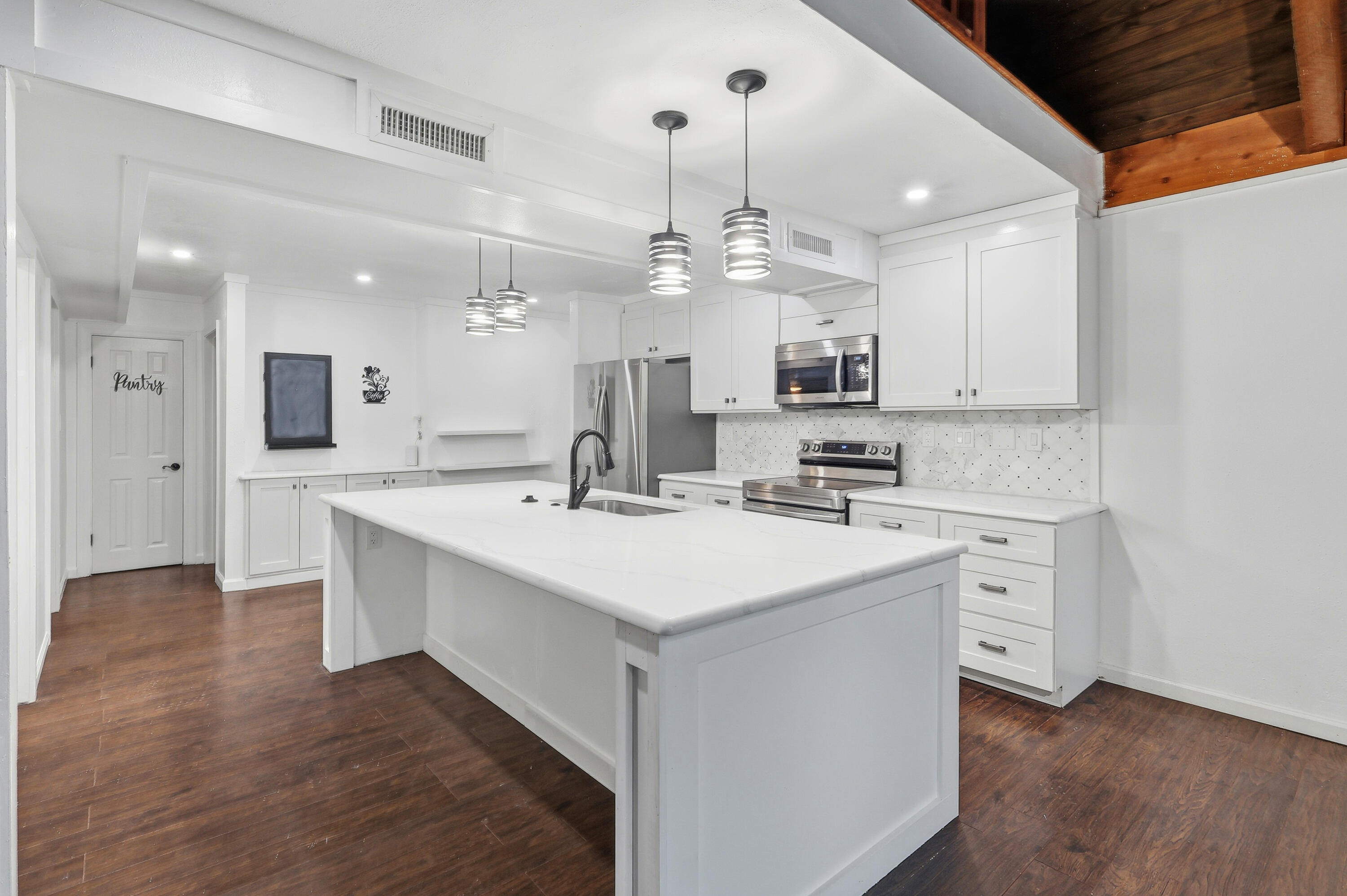 4578 Riley Road Milton, FL 32583 - Photo 15 of 55 a kitchen with a sink stainless steel appliances cabinets and a counter top space