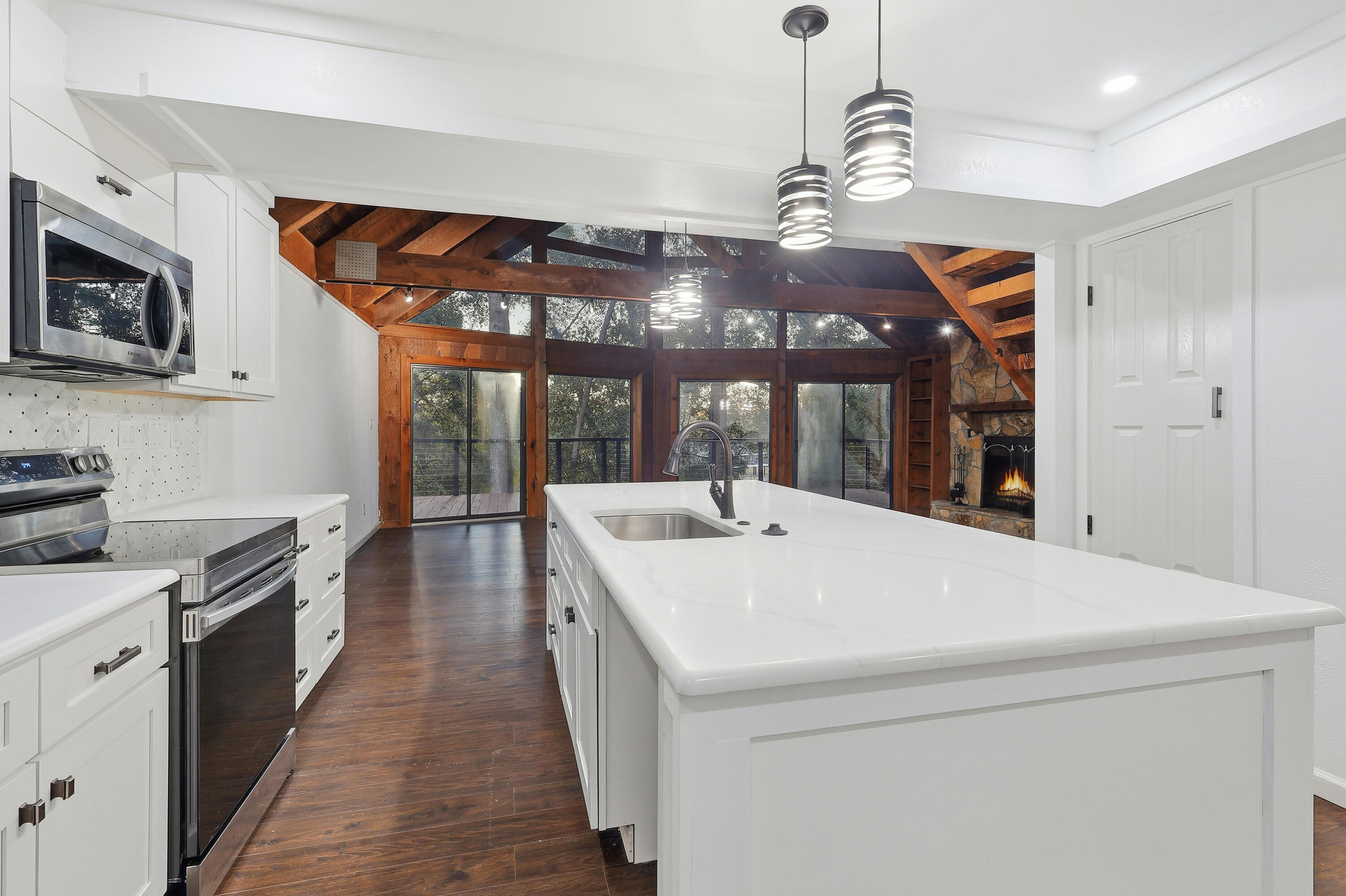 4578 Riley Road Milton, FL 32583 - Photo 17 of 55 a large white kitchen with stainless steel appliances granite countertop a sink and dishwasher a stove with wooden floor