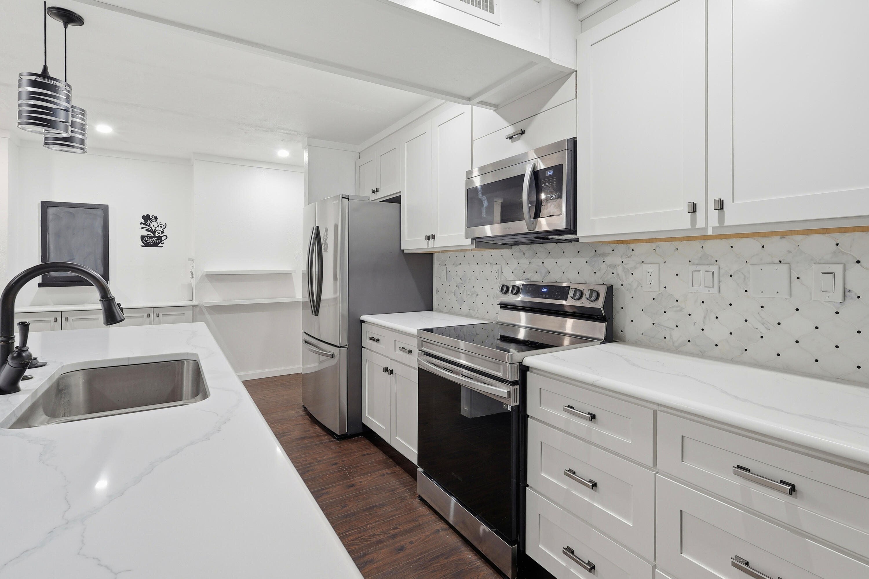 4578 Riley Road Milton, FL 32583 - Photo 20 of 55 a kitchen with stainless steel appliances granite countertop a sink and a stove