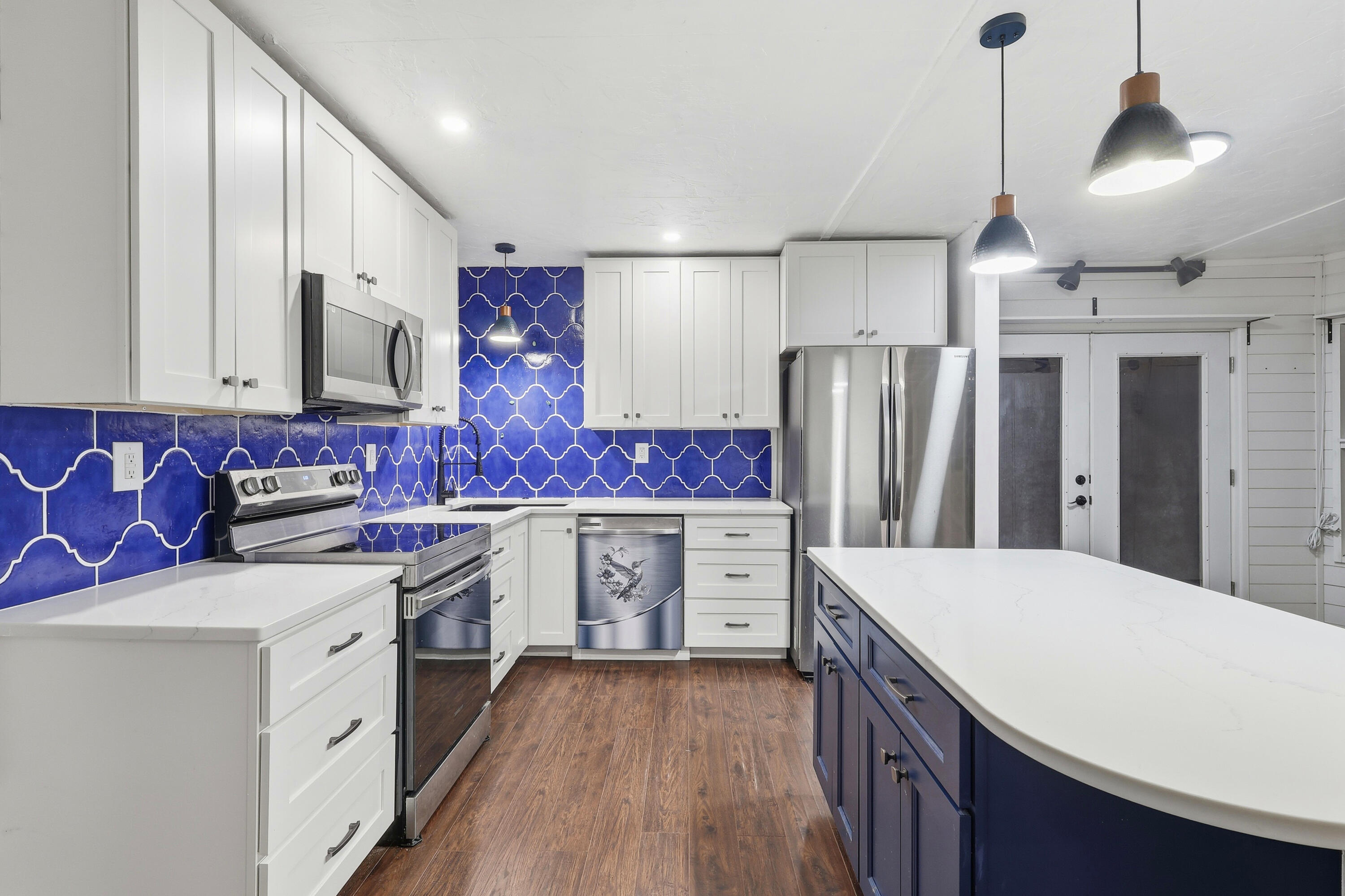 4578 Riley Road Milton, FL 32583 - Photo 21 of 55 a kitchen with stainless steel appliances a stove refrigerator sink and cabinets