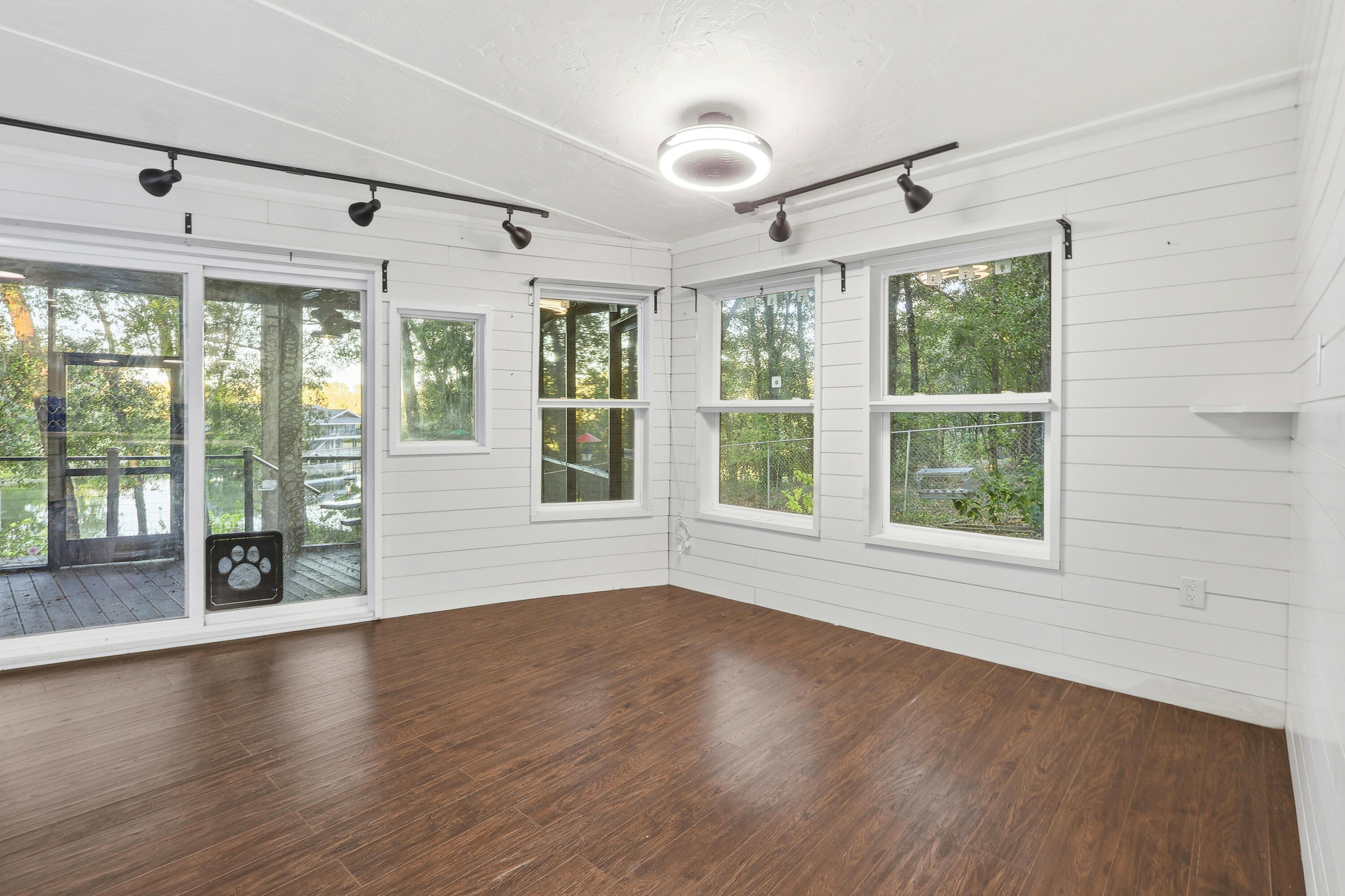 4578 Riley Road Milton, FL 32583 - Photo 29 of 55 a view of an empty room with wooden floor and a window