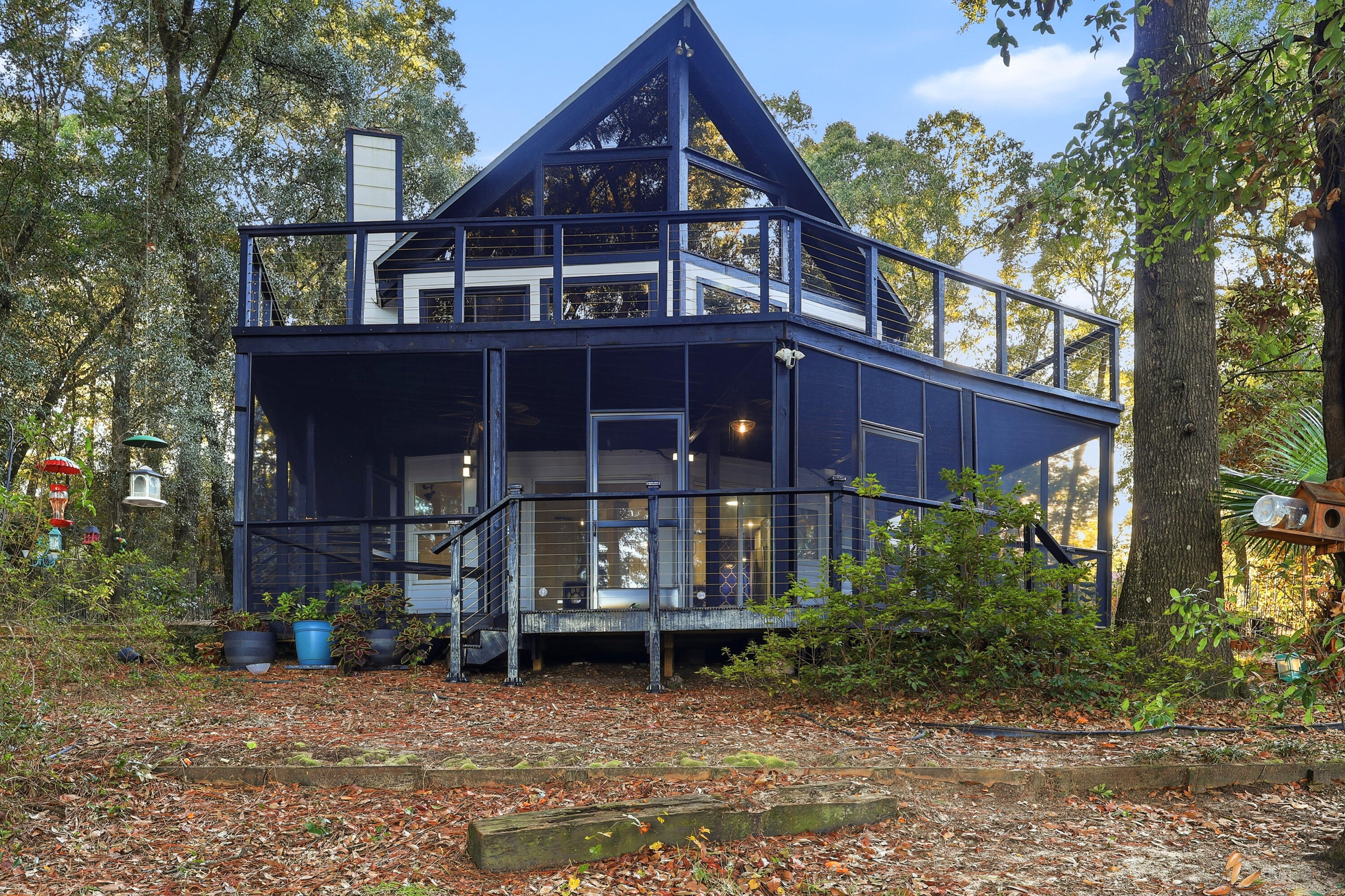 4578 Riley Road Milton, FL 32583 - Photo 48 of 55 a view of a big house with large tree and wooden fence