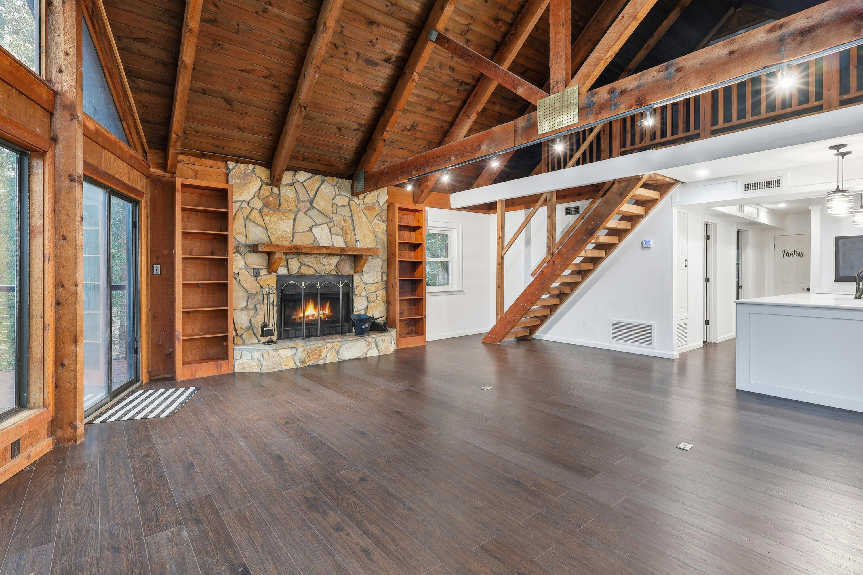 4578 Riley Road Milton, FL 32583 - Photo 5 of 55 a view of an empty room with wooden floor staircase and windows