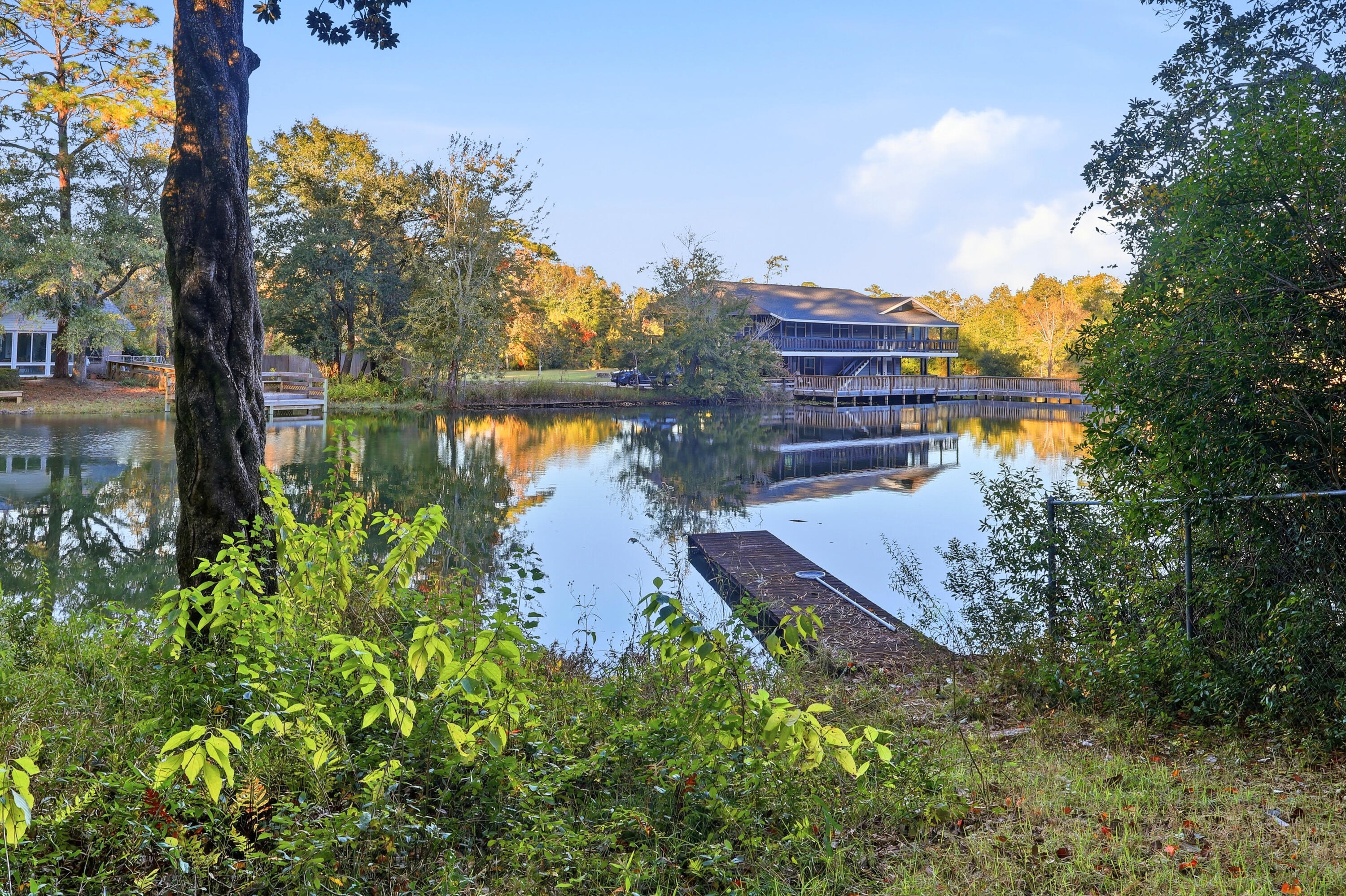 4578 Riley Road Milton, FL 32583 - Photo 54 of 55 a lake view with boat and trees in the background