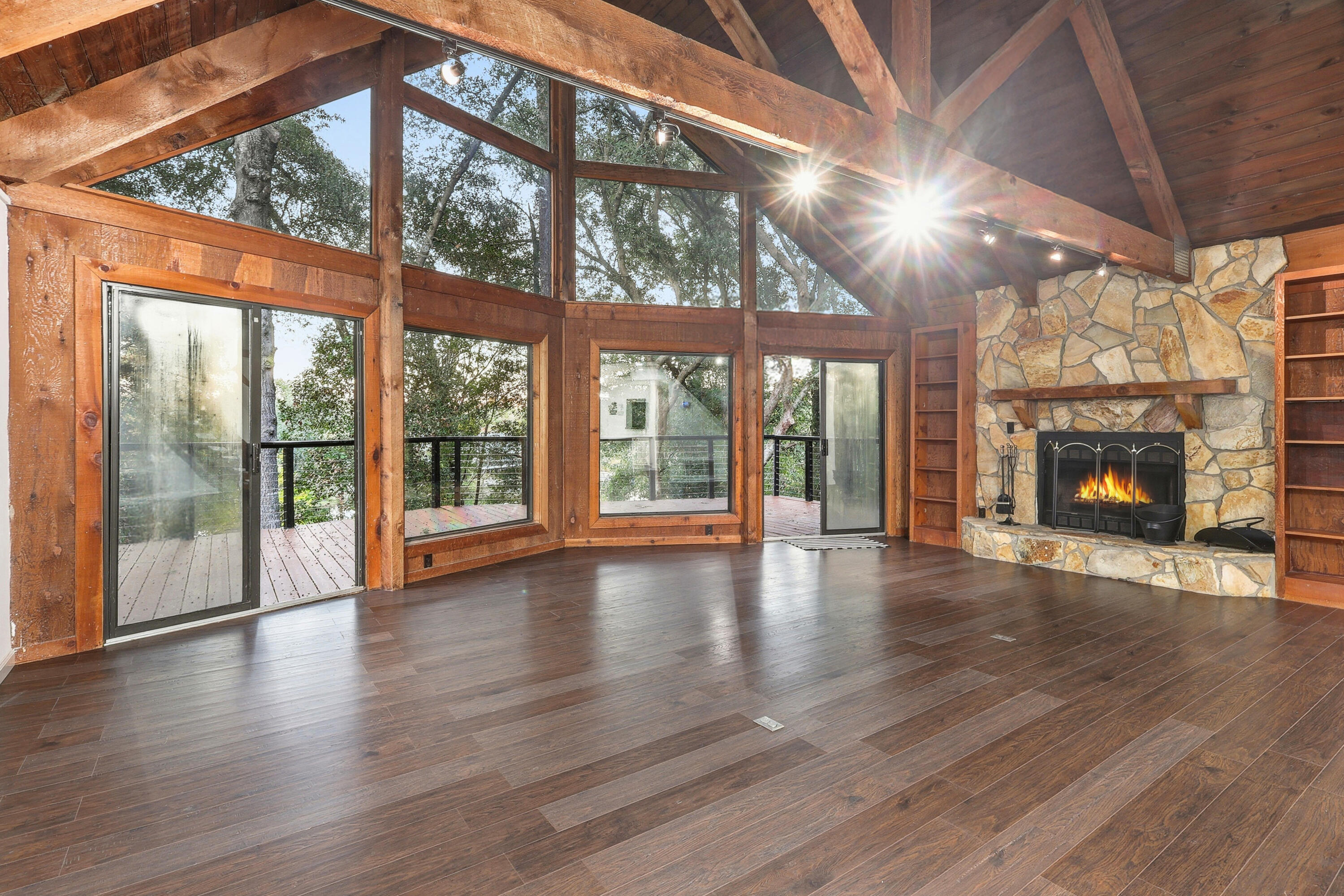 4578 Riley Road Milton, FL 32583 - Photo 6 of 55 a view of an empty room with wooden floor and a fireplace