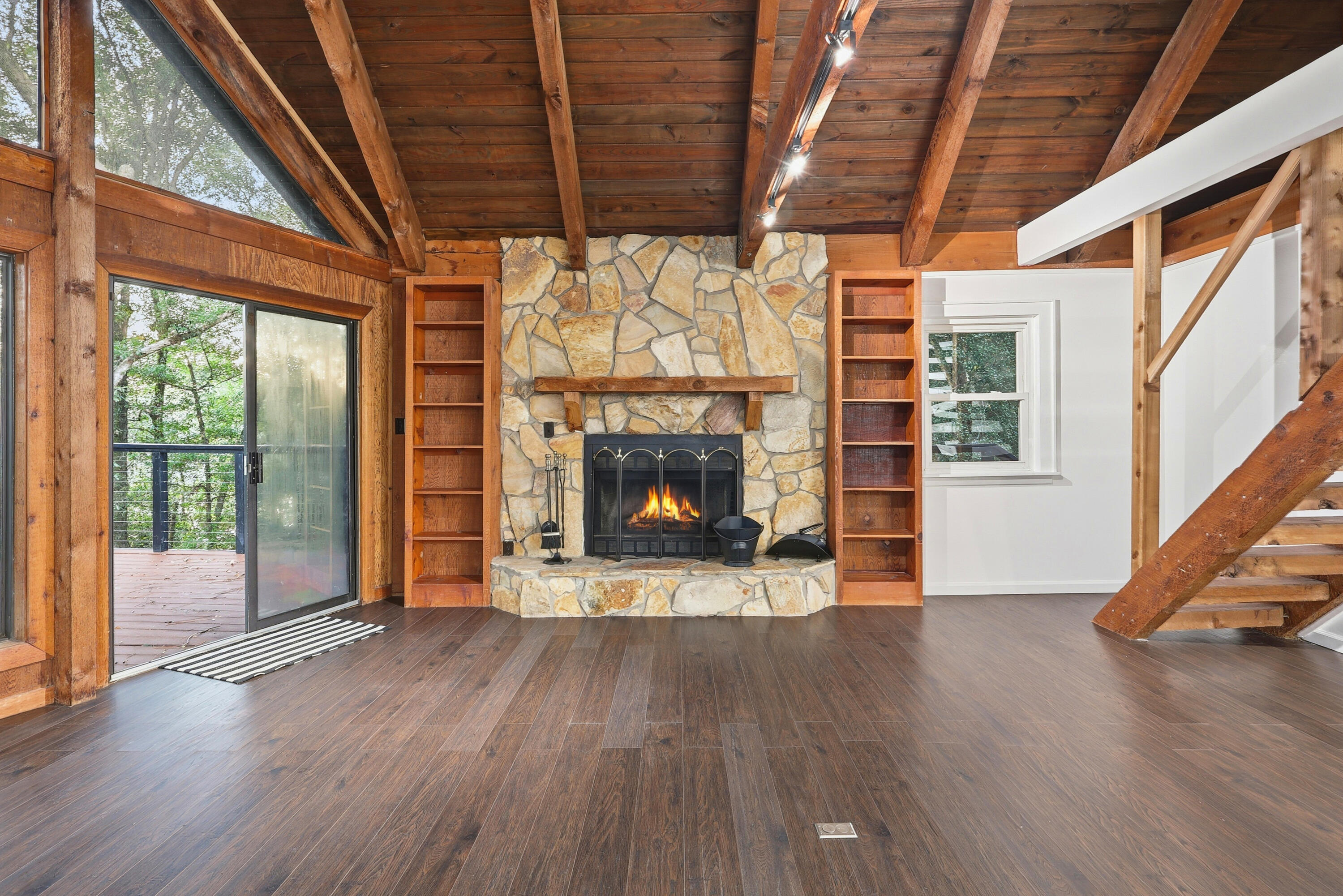 4578 Riley Road Milton, FL 32583 - Photo 7 of 55 a view of an empty room with wooden floor fireplace and a window