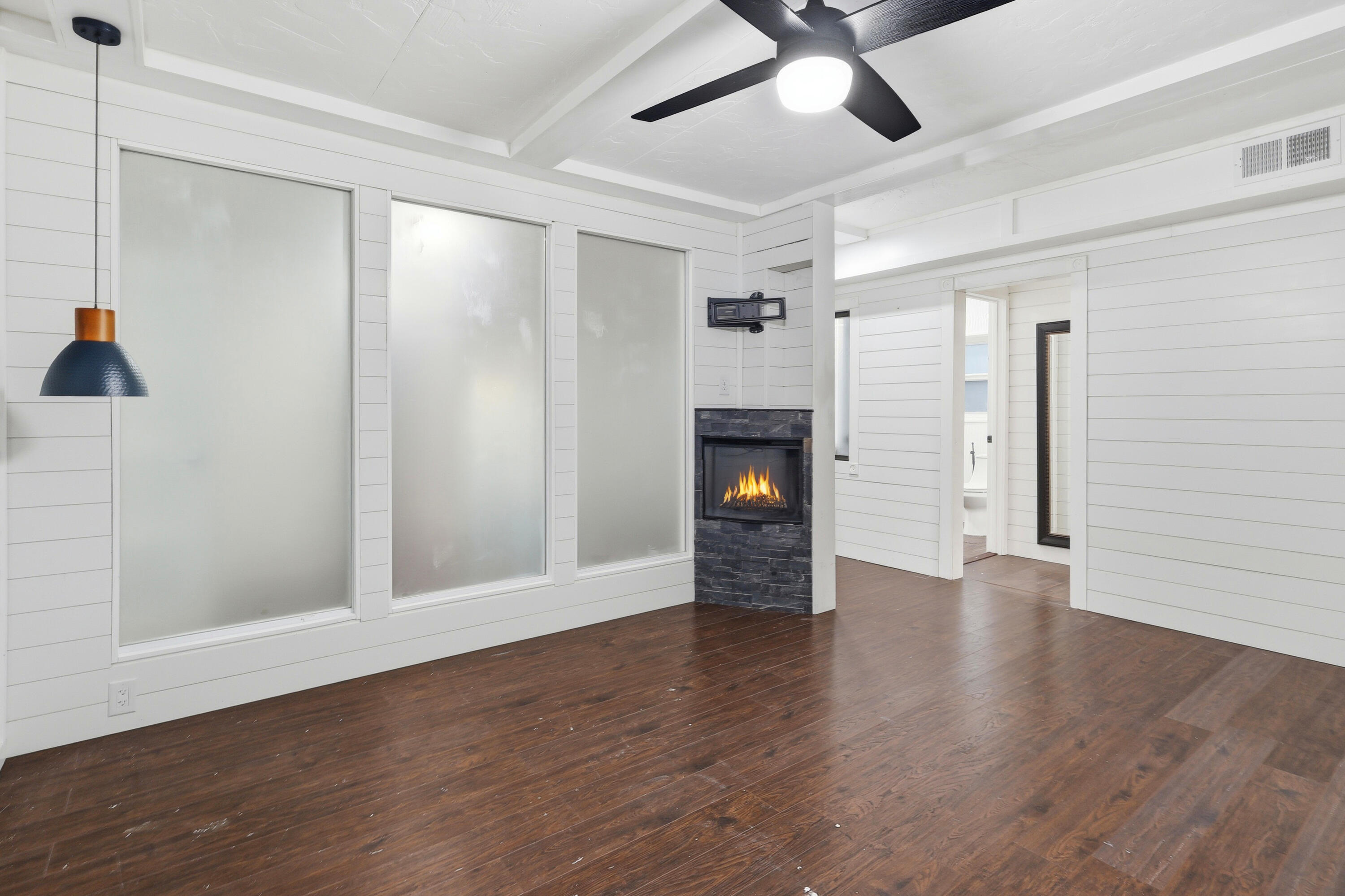4578 Riley Road Milton, FL 32583 - Photo 10 of 55 a view of an empty room with wooden floor and a window