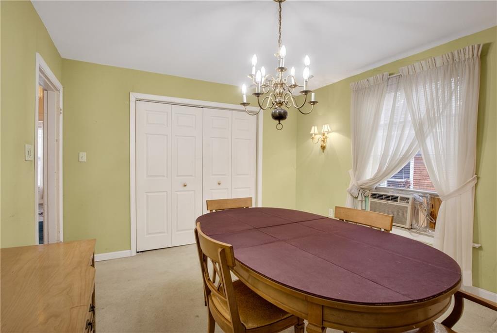 417 Zara Street Pittsburgh, PA 15210 - Photo 22 of 47 a view of a dining room with furniture and chandelier