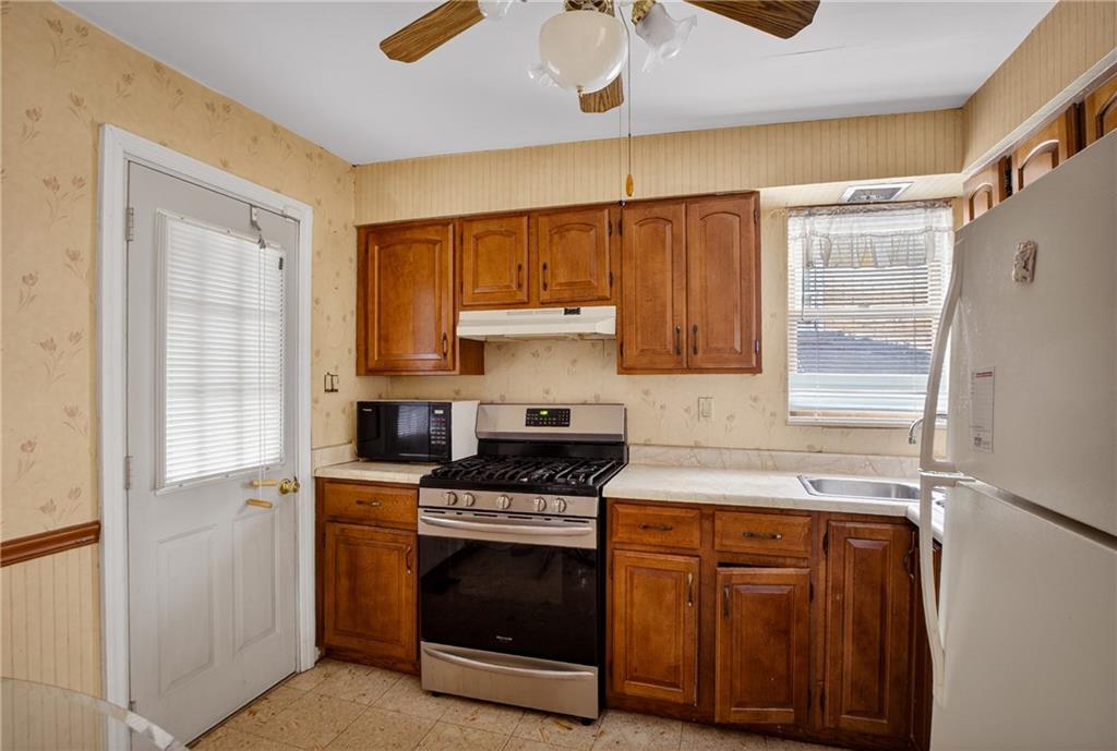 417 Zara Street Pittsburgh, PA 15210 - Photo 26 of 47 a kitchen with a stove microwave and a refrigerator