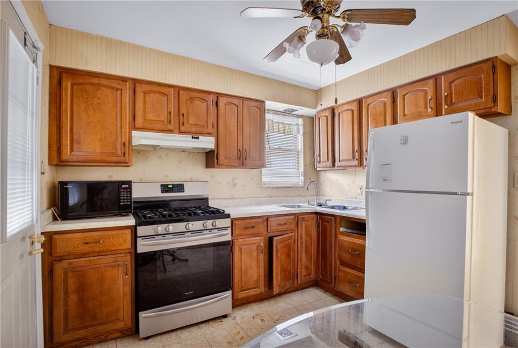 417 Zara Street Pittsburgh, PA 15210 - Photo 28 of 47 a kitchen with a stove a sink and a refrigerator