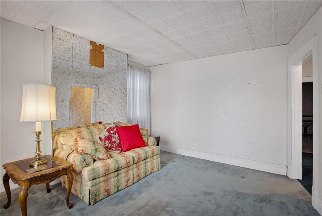417 Zara Street Pittsburgh, PA 15210 - Photo 34 of 47 a living room with furniture and a lamp