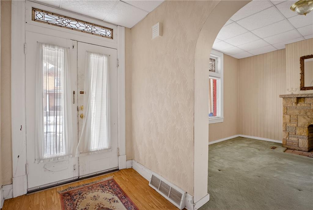 417 Zara Street Pittsburgh, PA 15210 - Photo 6 of 47 an entryway with a window and wooden floor