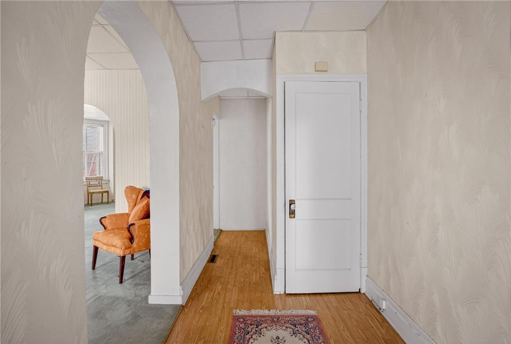 417 Zara Street Pittsburgh, PA 15210 - Photo 7 of 47 a view of a hallway with entryway wooden floor and front door