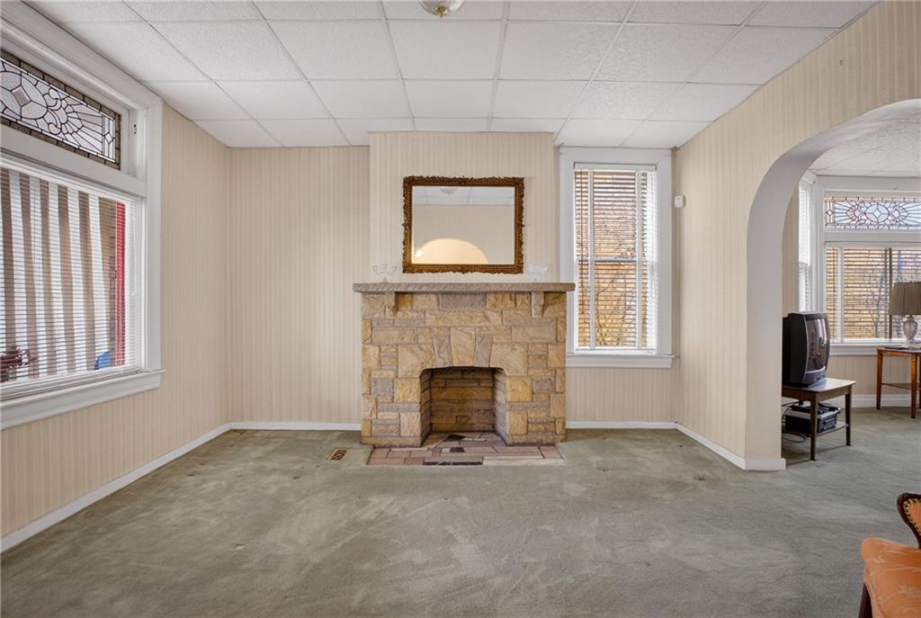 417 Zara Street Pittsburgh, PA 15210 - Photo 8 of 47 a living room with furniture and a fireplace