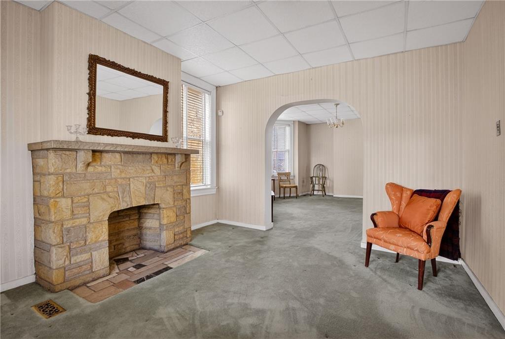 417 Zara Street Pittsburgh, PA 15210 - Photo 9 of 47 a living room with furniture and a fireplace