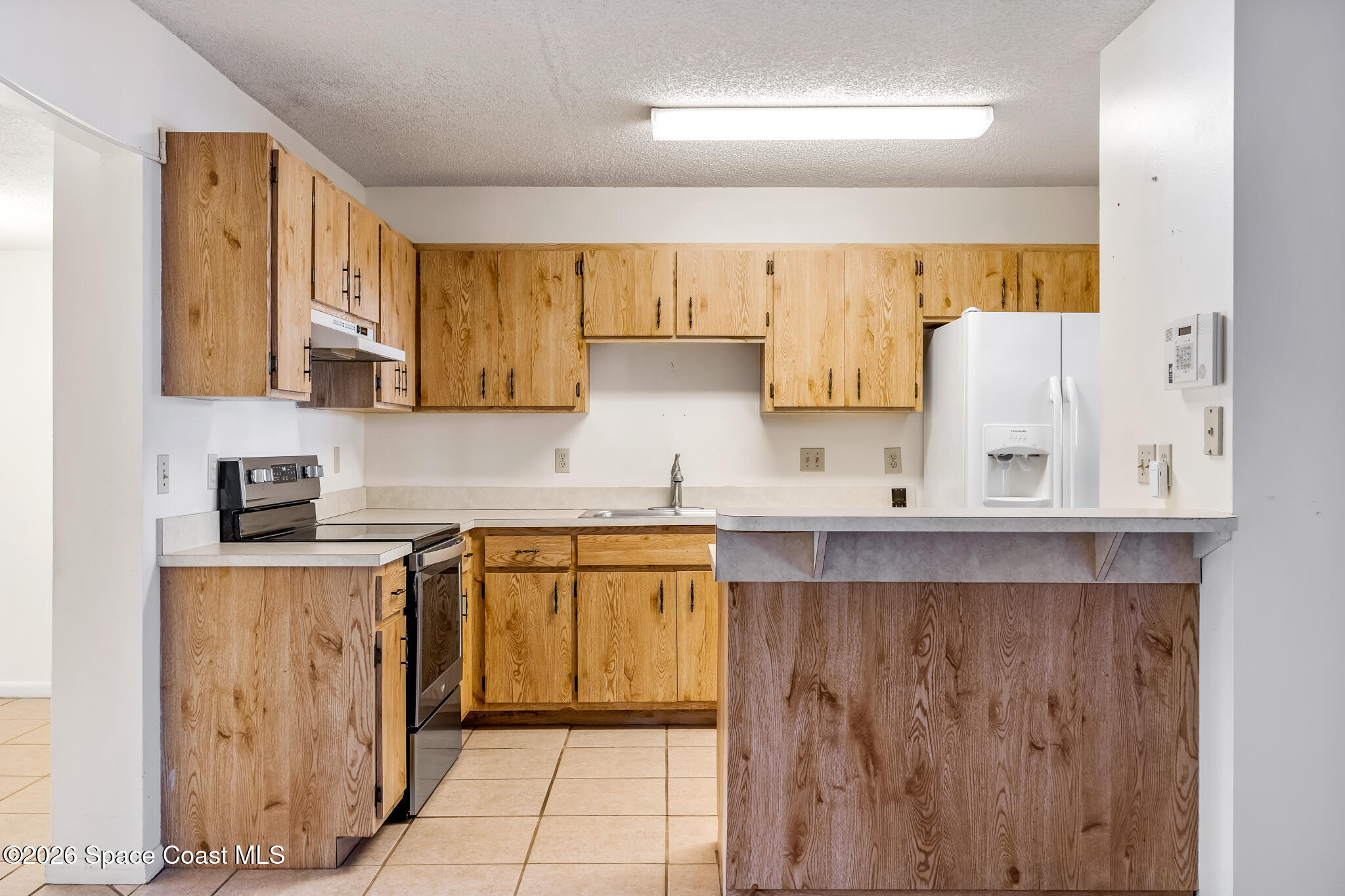 2016 Manor Drive Northeast Palm Bay, FL 32905 - Photo 11 of 29 a kitchen with stainless steel appliances granite countertop a sink and cabinets