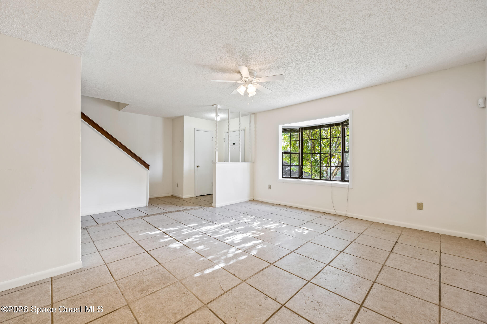 2016 Manor Drive Northeast Palm Bay, FL 32905 - Photo 15 of 29 a view of an empty room with windows and chandelier fan