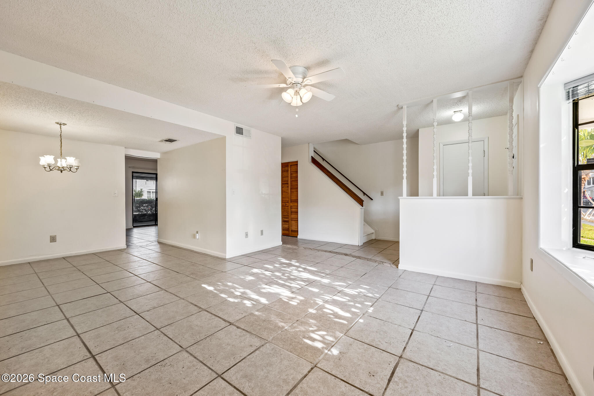 2016 Manor Drive Northeast Palm Bay, FL 32905 - Photo 16 of 29 a view of a livingroom with a ceiling fan and window