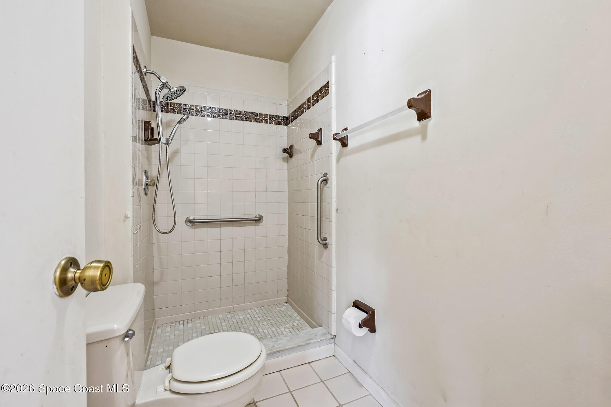 2016 Manor Drive Northeast Palm Bay, FL 32905 - Photo 24 of 29 a bathroom with a toilet and a shower
