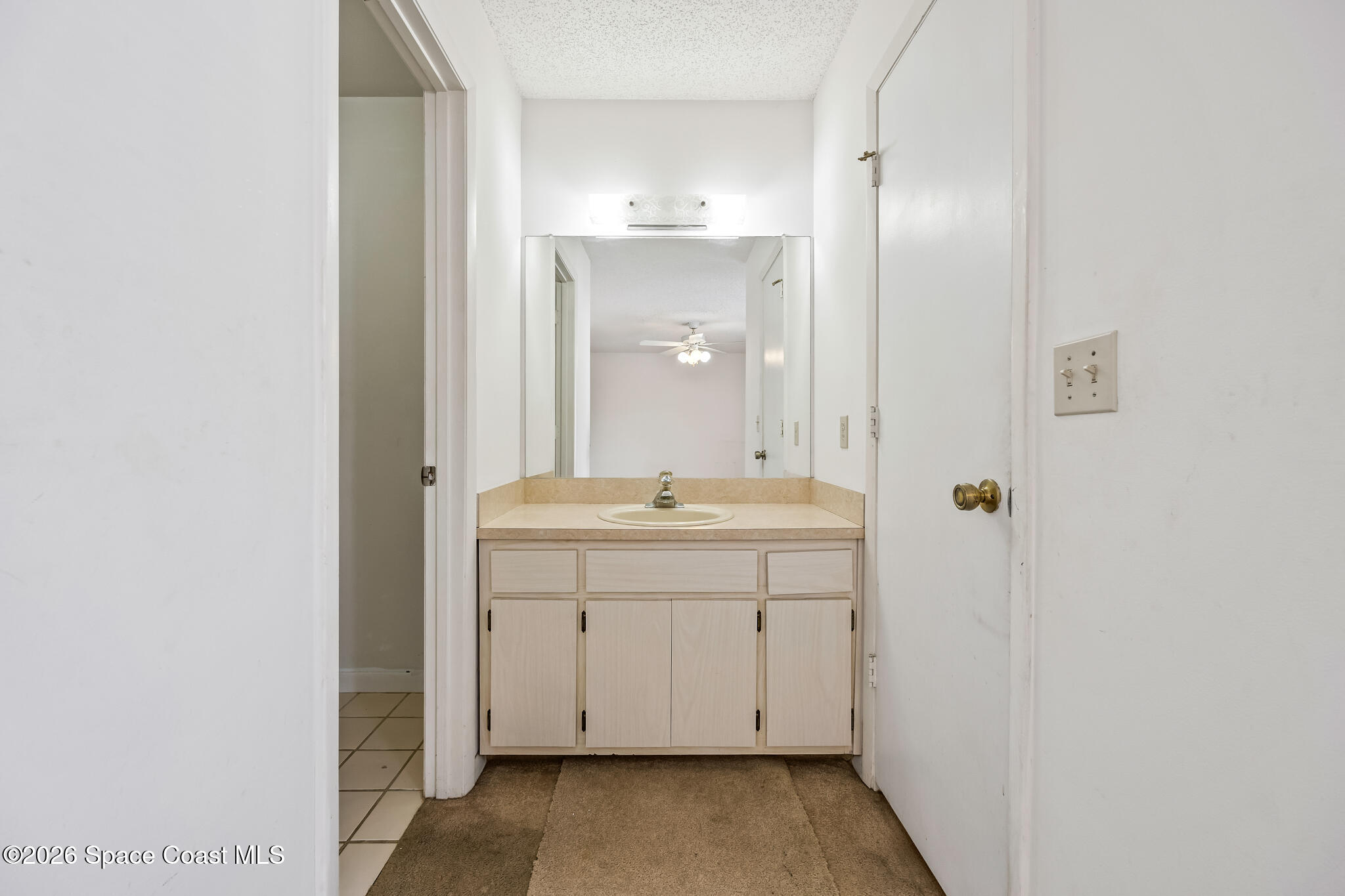 2016 Manor Drive Northeast Palm Bay, FL 32905 - Photo 25 of 29 a bathroom with a sink a mirror and a vanity