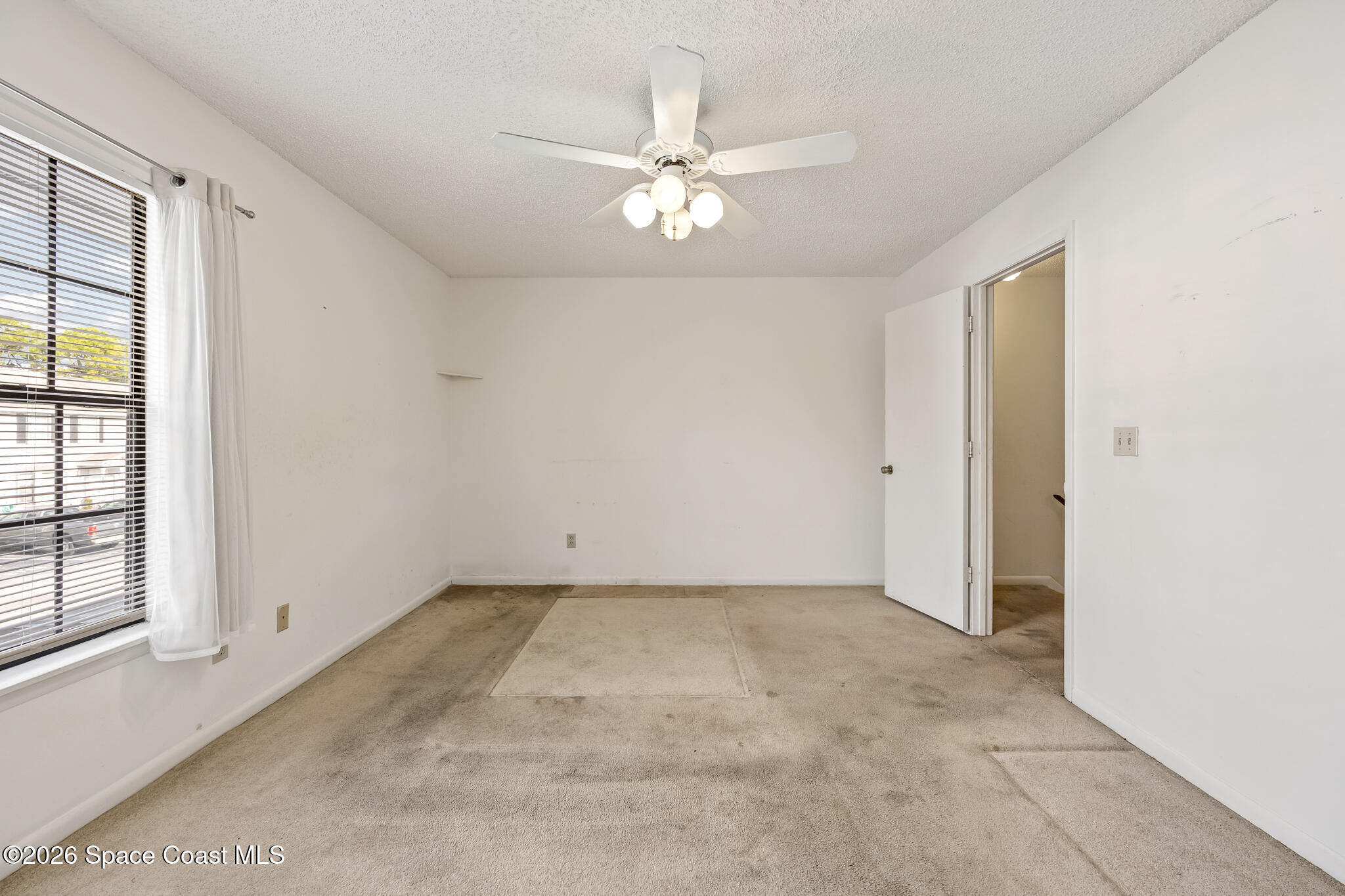 2016 Manor Drive Northeast Palm Bay, FL 32905 - Photo 26 of 29 an empty room with chandelier fan and windows
