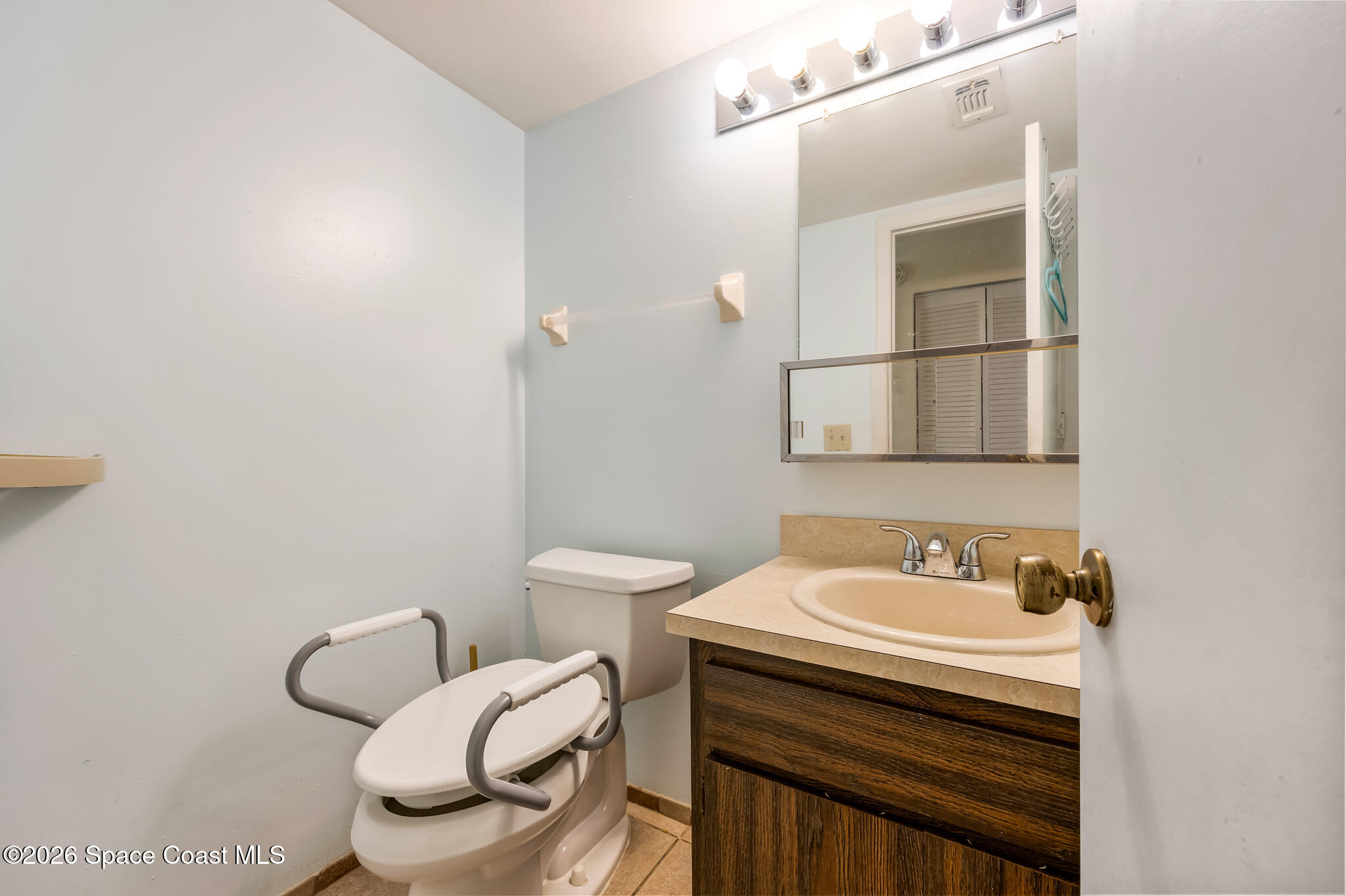 2016 Manor Drive Northeast Palm Bay, FL 32905 - Photo 10 of 29 a bathroom with a sink toilet and mirror
