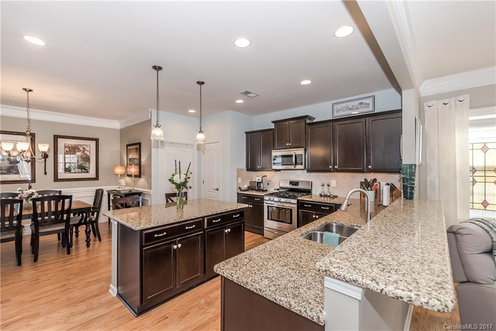 4285 Perth Road Indian Land, SC 29707 - Photo 6 of 24 a kitchen with stainless steel appliances granite countertop a sink stove and refrigerator