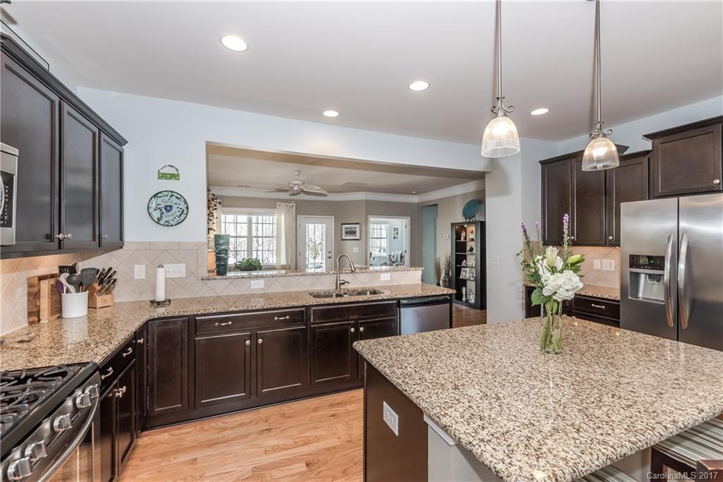 4285 Perth Road Indian Land, SC 29707 - Photo 7 of 24 a large kitchen with granite countertop a sink and stove