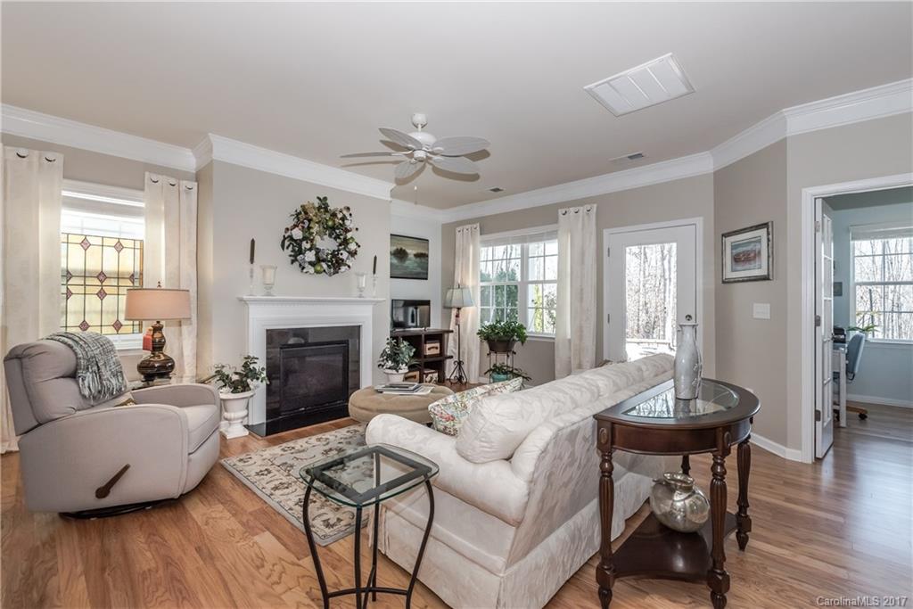 4285 Perth Road Indian Land, SC 29707 - Photo 8 of 24 a living room with furniture a fireplace and a large mirror