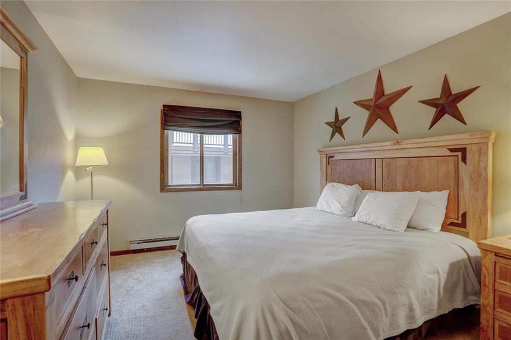325 Four Oclock Road, Unit C203 Breckenridge, CO 80424 - Photo 11 of 35 a bedroom with a bed and a sink