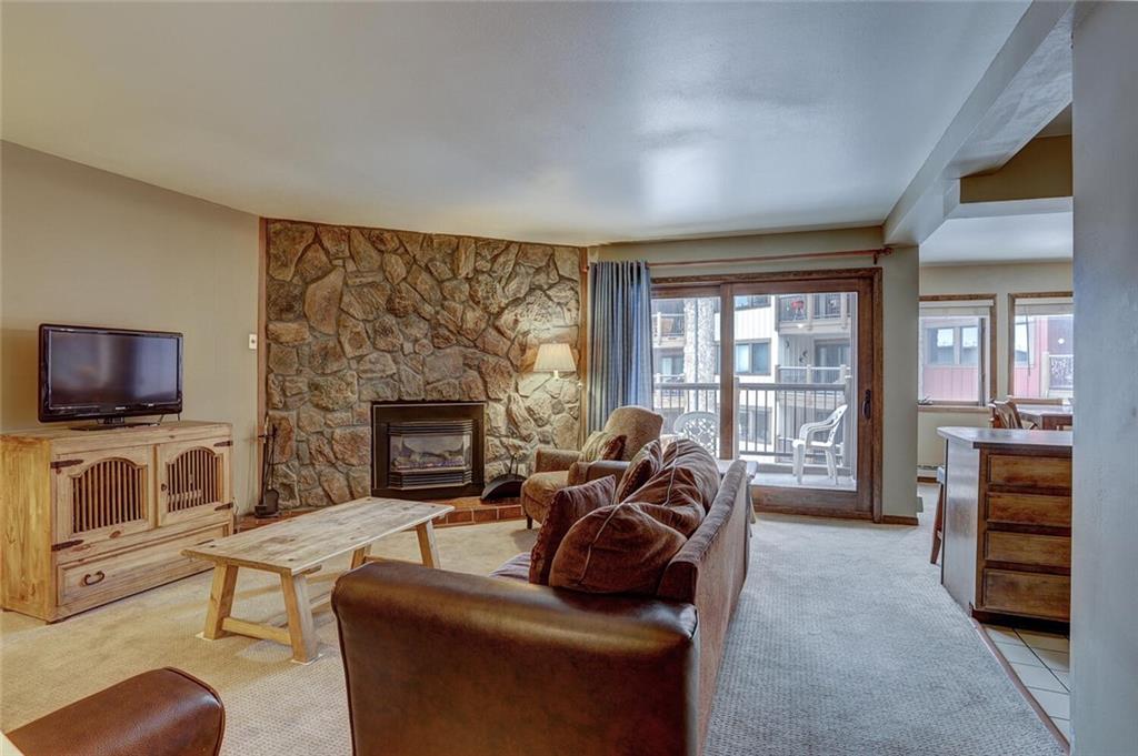 325 Four Oclock Road, Unit C203 Breckenridge, CO 80424 - Photo 13 of 35 a living room with furniture a flat screen tv and a fireplace