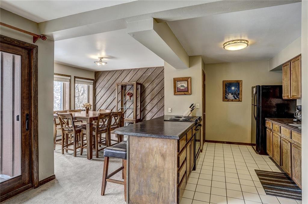 325 Four Oclock Road, Unit C203 Breckenridge, CO 80424 - Photo 14 of 35 a very nice looking kitchen with wooden floor and a dining table