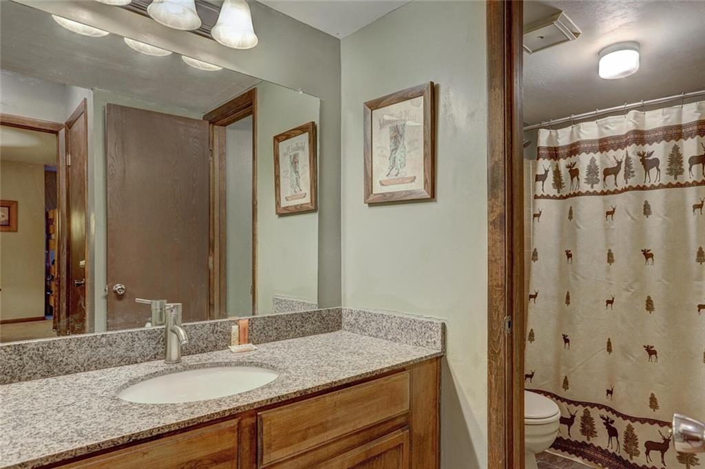 325 Four Oclock Road, Unit C203 Breckenridge, CO 80424 - Photo 15 of 35 a bathroom with a granite countertop sink a mirror and a shower