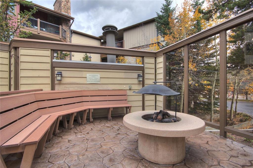 325 Four Oclock Road, Unit C203 Breckenridge, CO 80424 - Photo 16 of 35 a view of a patio with a table chairs and a grill