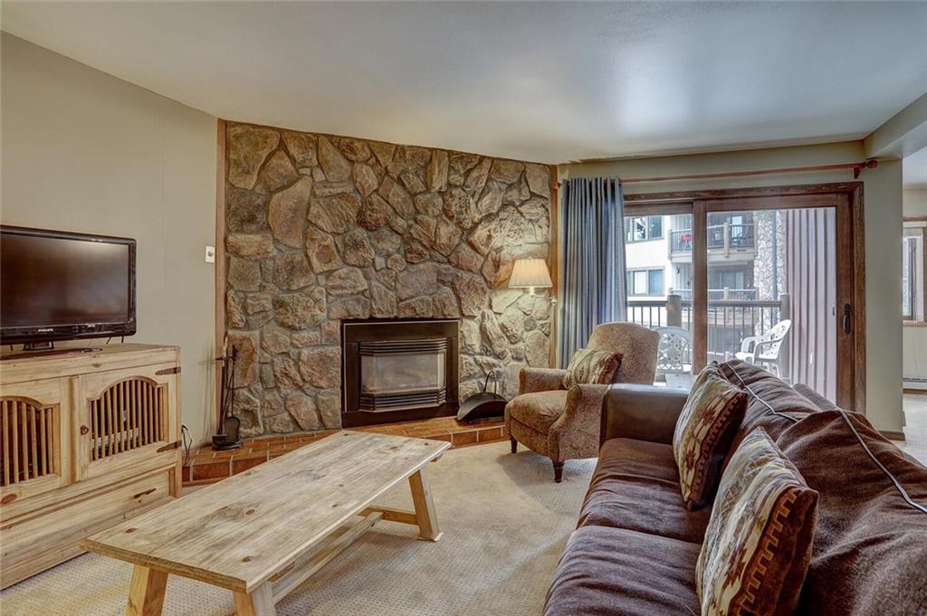 325 Four Oclock Road, Unit C203 Breckenridge, CO 80424 - Photo 17 of 35 a living room with furniture a flat screen tv and a fireplace